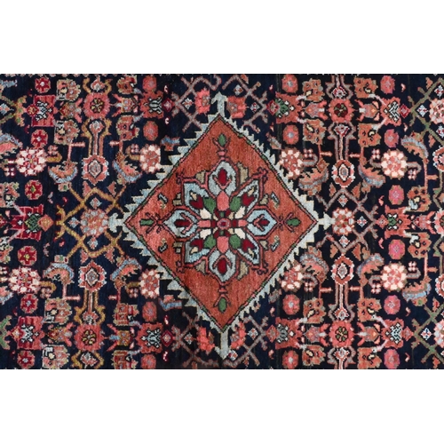 825 - An old North West Persian Mahal rug, the blue ground with centre medallion in red, 200 cm x 125 cm