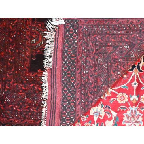 826 - An old Belouch rug, the brown-red ground with stylised lozenge guls, 214 cm x 140 cm