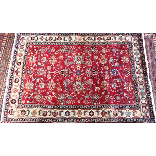 827 - A contemporary North West Persian Tabriz rug, the red ground with flowering vine design, 205 cm x 14... 