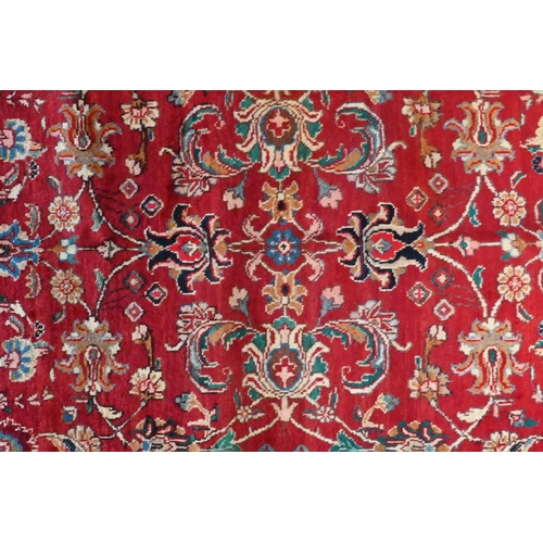 827 - A contemporary North West Persian Tabriz rug, the red ground with flowering vine design, 205 cm x 14... 