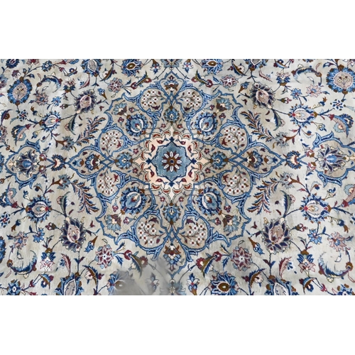 833 - A contemporary central Persian Kashan carpet, the pale jade and camel ground with stylised floral de... 