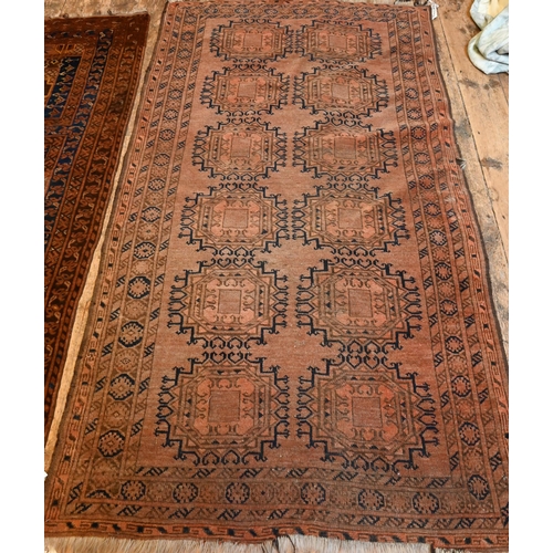 836 - An old Afghan brown-red ground gul design rug, 207 cm x 117 cm to/with an old Belouch rug, brown-red... 