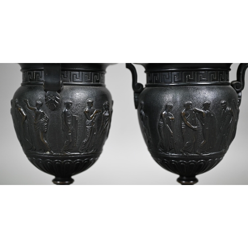 841 - A pair of 19th century Neo-Classical style dark patinated bronze table urns, on conforming bases and... 