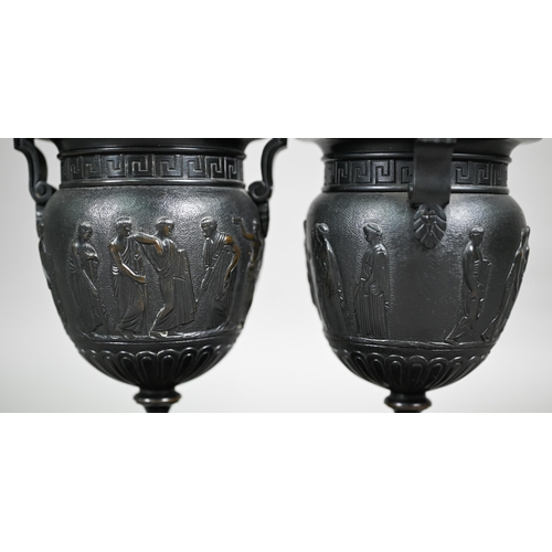 841 - A pair of 19th century Neo-Classical style dark patinated bronze table urns, on conforming bases and... 