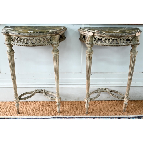 854 - A pair of antique continental carved lime wood demi-lune console tables, the (loose) tops with aged ... 