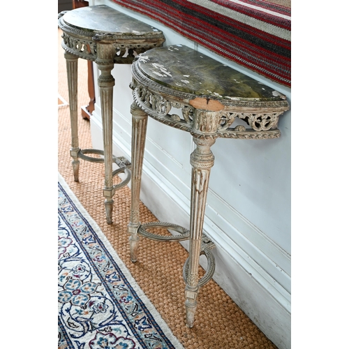 854 - A pair of antique continental carved lime wood demi-lune console tables, the (loose) tops with aged ... 