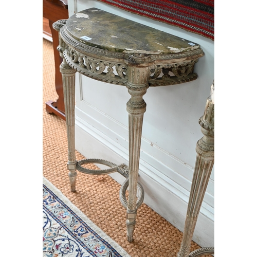 854 - A pair of antique continental carved lime wood demi-lune console tables, the (loose) tops with aged ... 