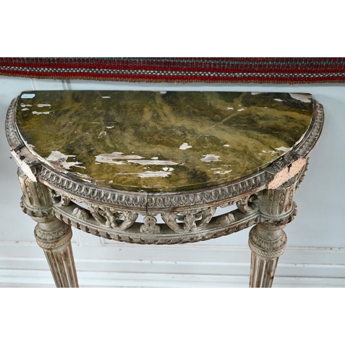 854 - A pair of antique continental carved lime wood demi-lune console tables, the (loose) tops with aged ... 