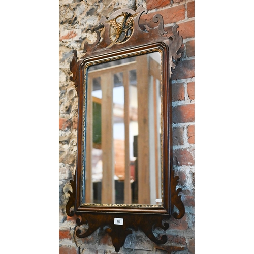 863 - A Georgian style mahogany and gilt framed fret cut mirror, surmounted by a ho-ho bird, 91 cm x 50 cm