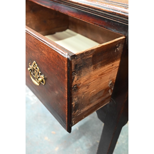 866 - An 18th century oak low dresser, the wide single plank top over three drawers within a shaped apron,... 