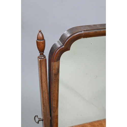 869 - A George III cross-banded walnut toilet mirror, raised on a three drawer base on ogee moulded bracke... 