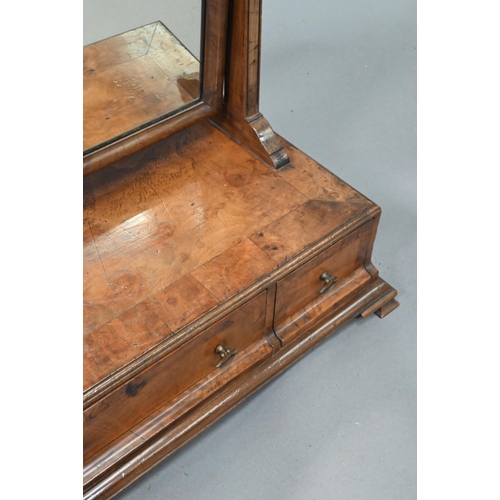 869 - A George III cross-banded walnut toilet mirror, raised on a three drawer base on ogee moulded bracke... 