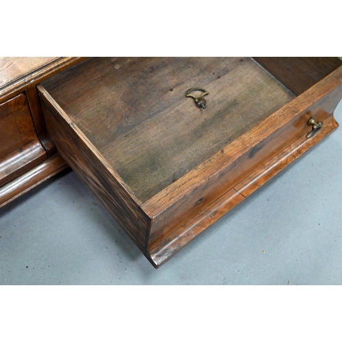 869 - A George III cross-banded walnut toilet mirror, raised on a three drawer base on ogee moulded bracke... 