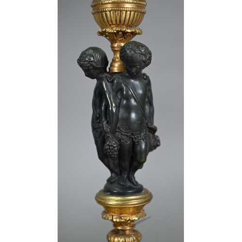 872 - A pair of fine quality neo-classical styled bronze and ormolu candlesticks, centred by a trio of Bac... 