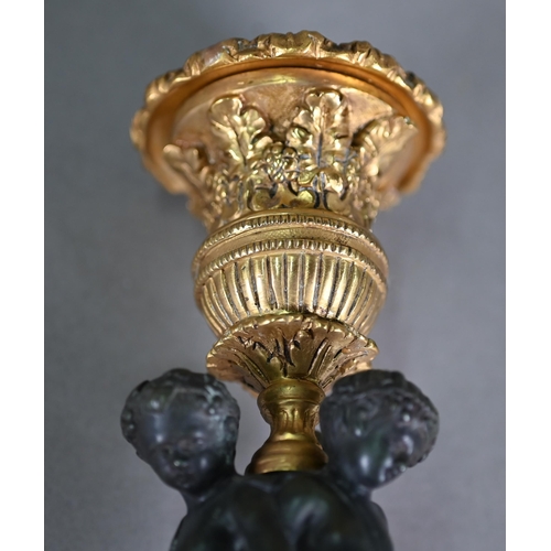 872 - A pair of fine quality neo-classical styled bronze and ormolu candlesticks, centred by a trio of Bac... 