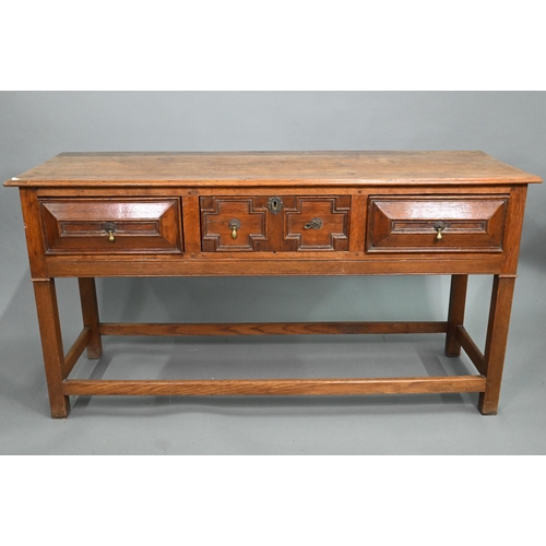 875 - An 18th century style three drawer low dresser, the centre drawer with applied geometric mouldings, ... 