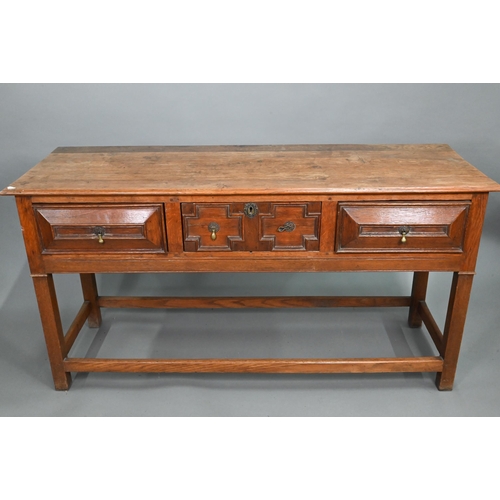 875 - An 18th century style three drawer low dresser, the centre drawer with applied geometric mouldings, ... 