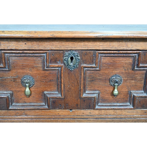 875 - An 18th century style three drawer low dresser, the centre drawer with applied geometric mouldings, ... 