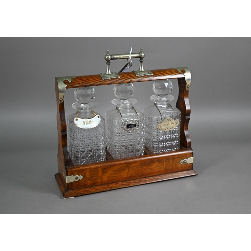 876 - An old silver plate mounted oak three bottle tantalus, 36 cm x 13 cm x 35 cm h (with key)