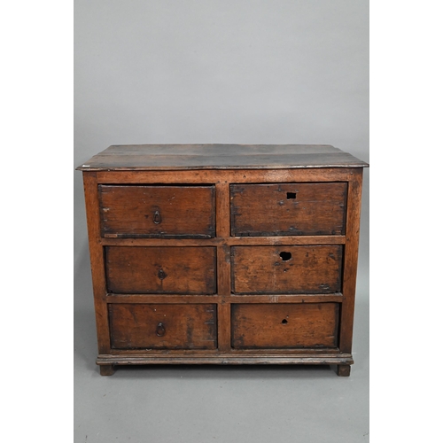 878 - A rustic late 17th/18th century joined oak framed six drawer chest, raised on stile feet, probably N... 