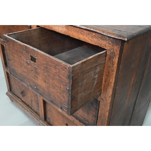 878 - A rustic late 17th/18th century joined oak framed six drawer chest, raised on stile feet, probably N... 