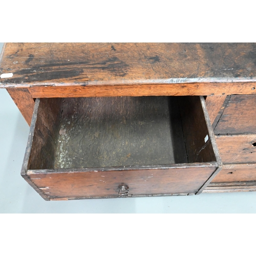 878 - A rustic late 17th/18th century joined oak framed six drawer chest, raised on stile feet, probably N... 