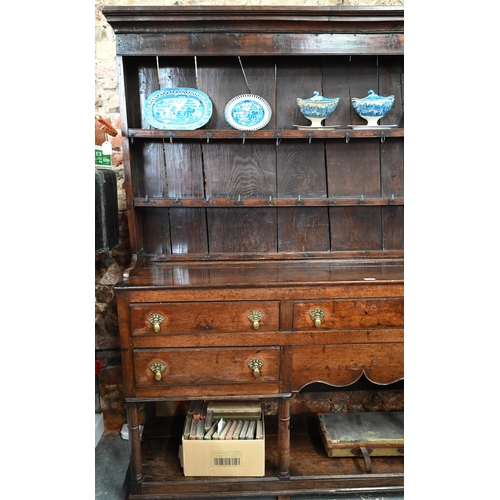 880 - An 18th century oak high dresser, the (associated) two tier rack with stepped canopy, planked back a... 