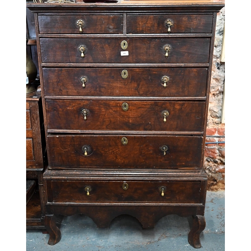 881 - A late 17th/18th century oak chest on stand, the two short over four long graduated drawers with lat... 