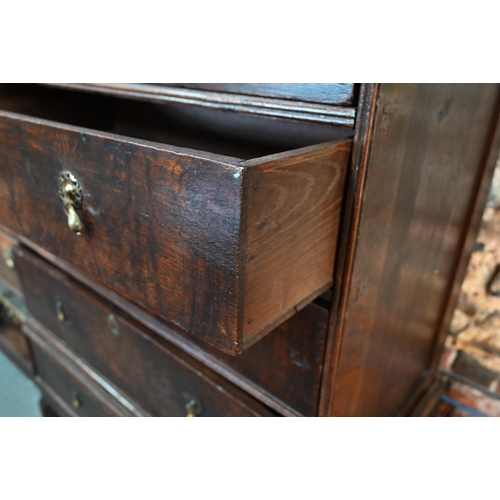 881 - A late 17th/18th century oak chest on stand, the two short over four long graduated drawers with lat... 