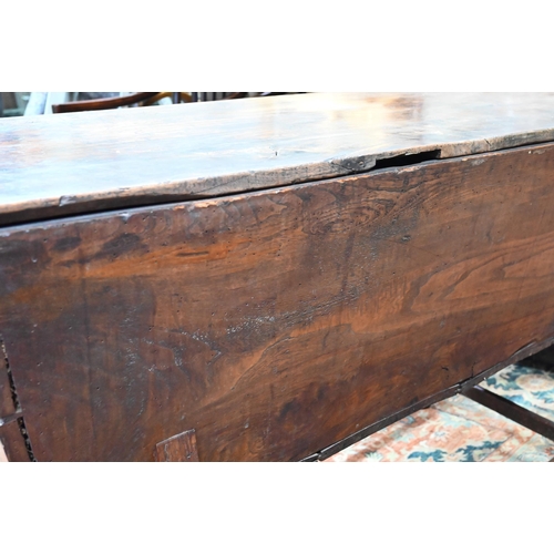 883 - An antique oak dough bin, oak and walnut, the tapered body with single plank top, raised on part tur... 