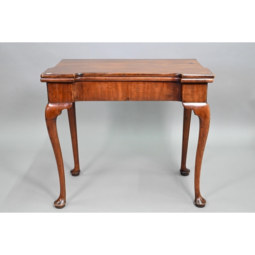 885 - A Georgian walnut folding tea table, raised on a single gateleg, on slender cabriole legs to pad fee... 