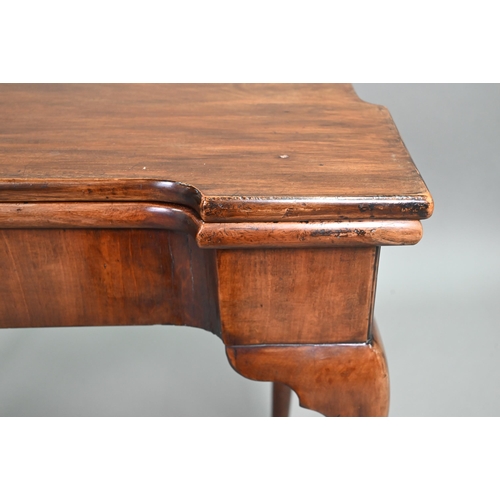 885 - A Georgian walnut folding tea table, raised on a single gateleg, on slender cabriole legs to pad fee... 