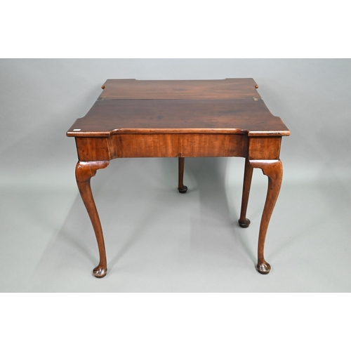 885 - A Georgian walnut folding tea table, raised on a single gateleg, on slender cabriole legs to pad fee... 