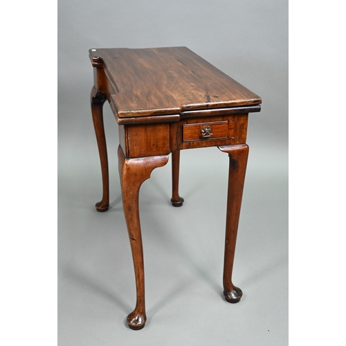 885 - A Georgian walnut folding tea table, raised on a single gateleg, on slender cabriole legs to pad fee... 