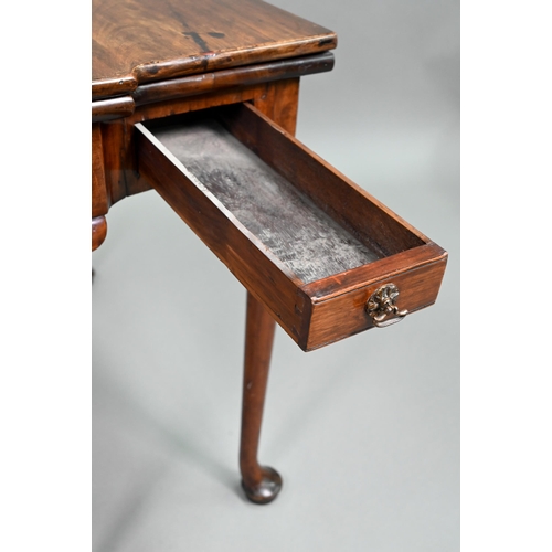 885 - A Georgian walnut folding tea table, raised on a single gateleg, on slender cabriole legs to pad fee... 