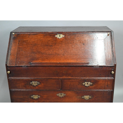 887 - An 18th century oak bureau, the fall enclosing a fitted interior of niches and slide top well over t... 