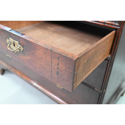 887 - An 18th century oak bureau, the fall enclosing a fitted interior of niches and slide top well over t... 