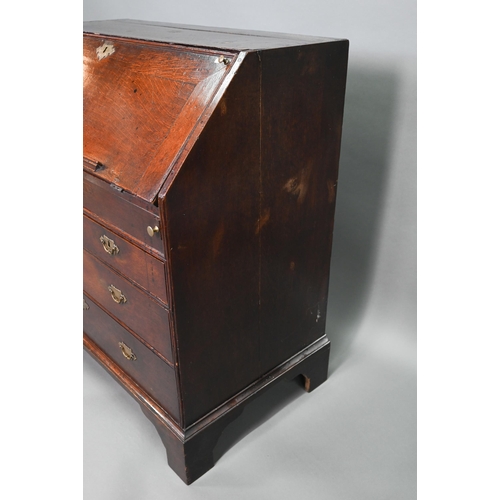 887 - An 18th century oak bureau, the fall enclosing a fitted interior of niches and slide top well over t... 