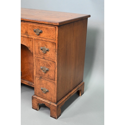 888 - A Georgian style cross-banded walnut kneehole desk, comprising a single long drawer over six short d... 