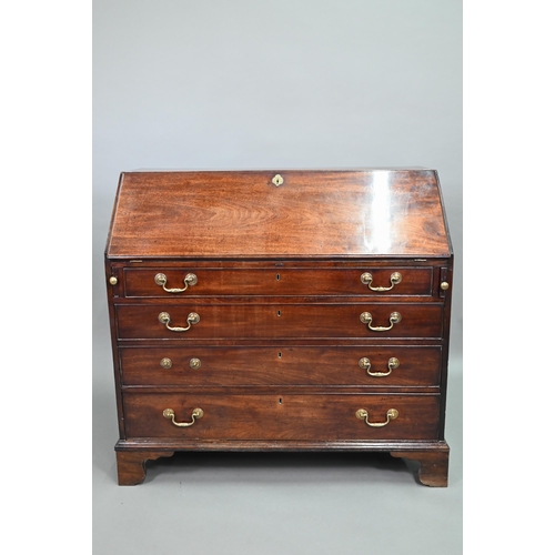 889 - A George III mahogany bureau, the well fitted interior with leather faux book spine 'secret' storage... 