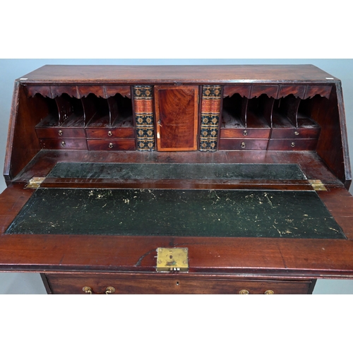 889 - A George III mahogany bureau, the well fitted interior with leather faux book spine 'secret' storage... 