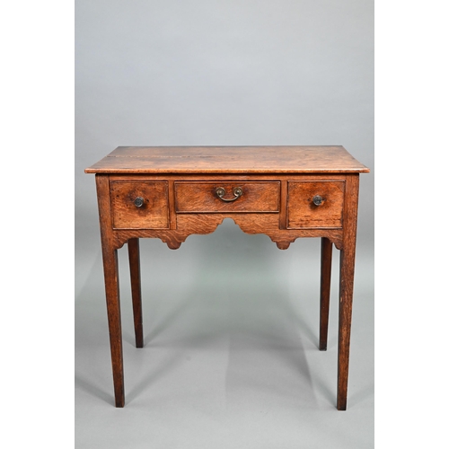 895 - An 18th century oak three drawer side table raised on square section legs