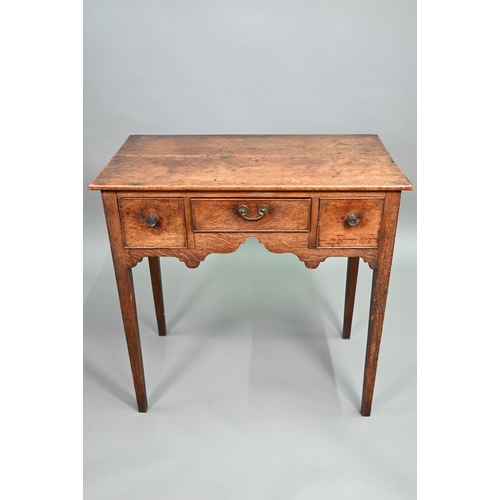 895 - An 18th century oak three drawer side table raised on square section legs