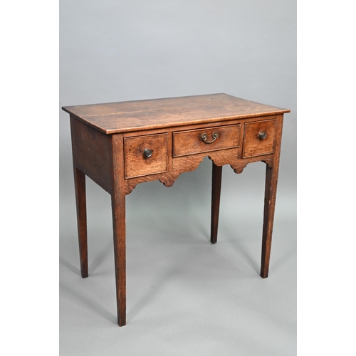 895 - An 18th century oak three drawer side table raised on square section legs