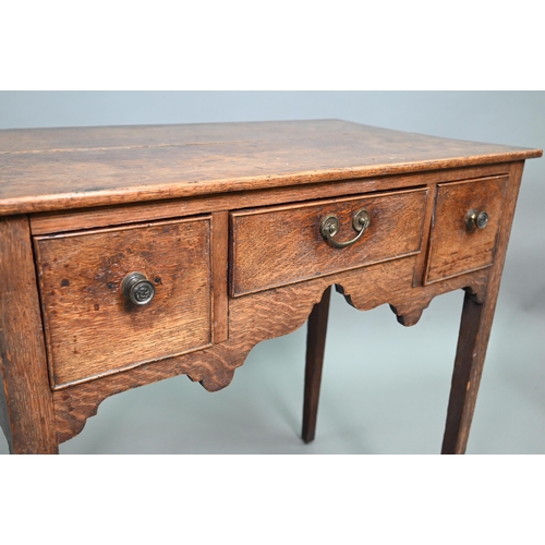 895 - An 18th century oak three drawer side table raised on square section legs