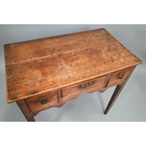 895 - An 18th century oak three drawer side table raised on square section legs