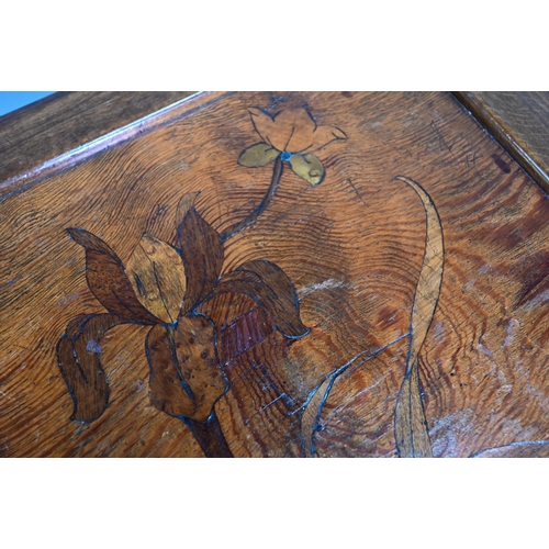 896 - An continental Art Nouveau period floral marquetry inlaid walnut revolving bookcase, raised on a sha... 