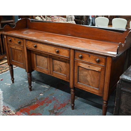 899 - A Victorian mahogany 3/4 galleried sideboard, with an arrangement of three drawers and centred by a ... 