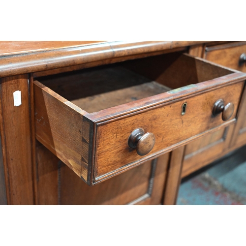 899 - A Victorian mahogany 3/4 galleried sideboard, with an arrangement of three drawers and centred by a ... 