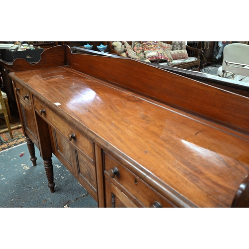 899 - A Victorian mahogany 3/4 galleried sideboard, with an arrangement of three drawers and centred by a ... 